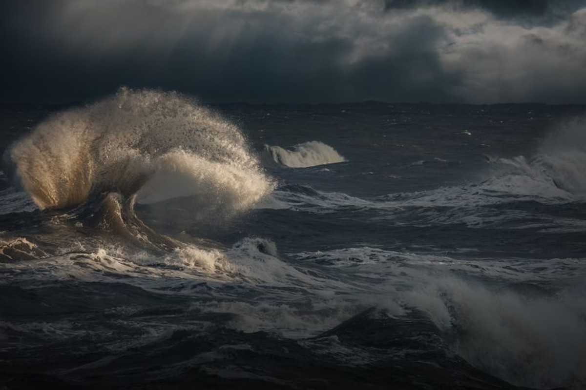 Large ocean waves rolling under a dark sky